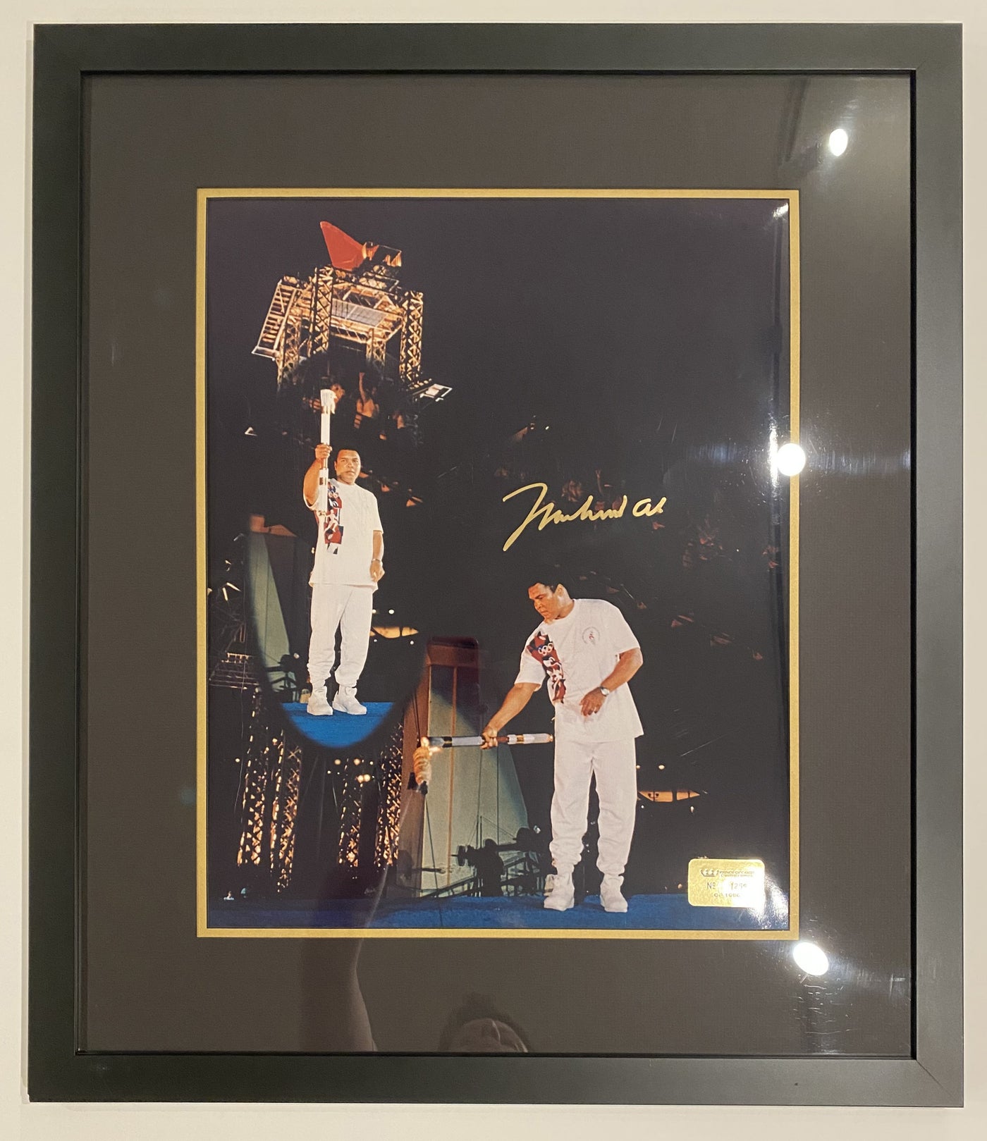 Photograph of Muhammad Ali Lighting 1996 Olympic Torch signed by Muhammad Ali