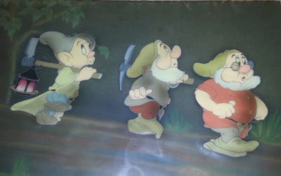 Original Walt Disney Production Cel on Courvoisier Background from Snow White and the Seven Dwarfs featuring Dopey, Sneezy and Doc