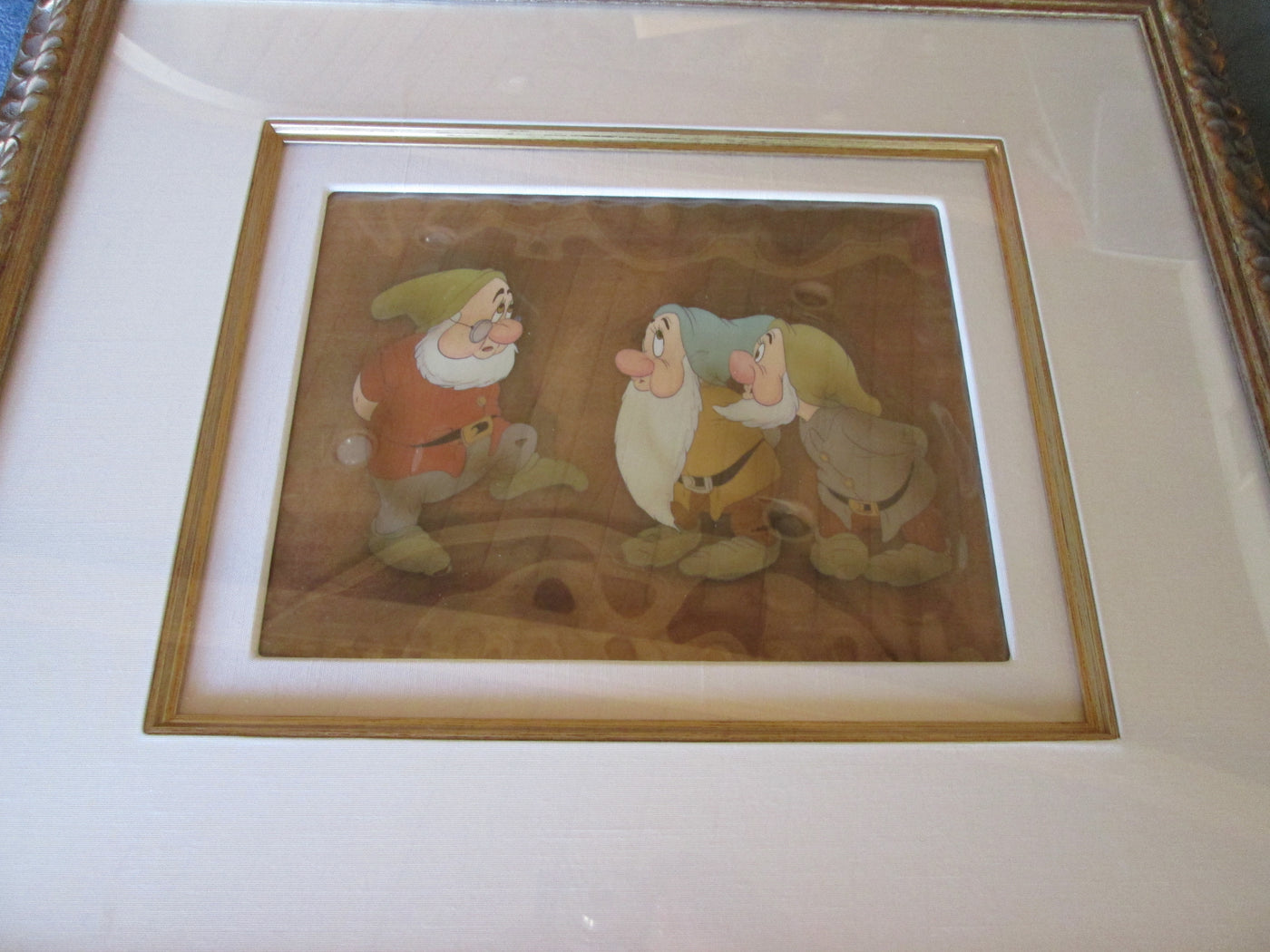Original Walt Disney Production Cel on Courvoisier Background from Snow White and the Seven Dwarfs featuring Doc, Bashful and Sneezy
