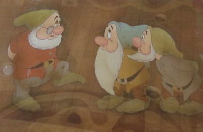 Original Walt Disney Production Cel on Courvoisier Background from Snow White and the Seven Dwarfs featuring Doc, Bashful and Sneezy