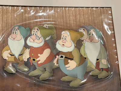 Original Walt Disney Production Cel on Courvoisier Background from Snow White and the Seven Dwarfs featuring Sneezy, Dopey, Sleepy, Doc, Bashful and Happy